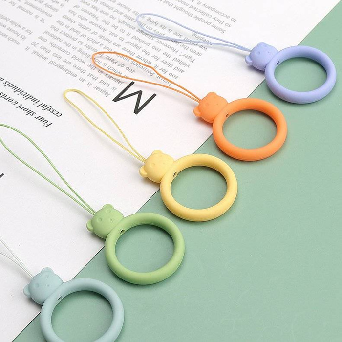 A silicone lanyard for a phone bear ring on a finger yellow